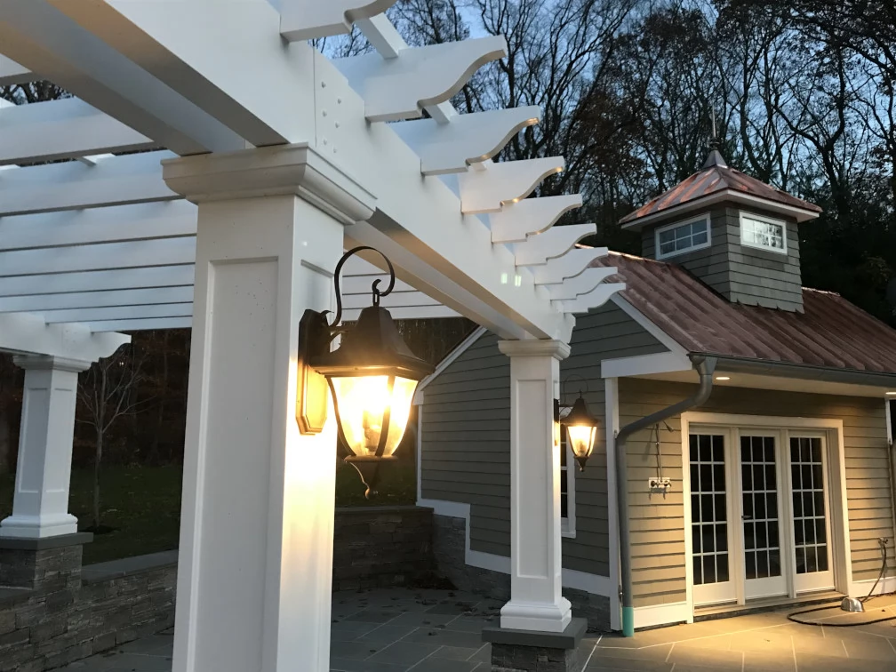A sconce light mounted to a hollow fiberglass column