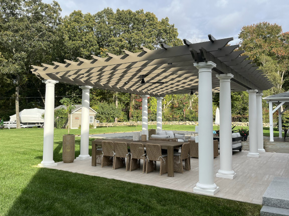 A simple fiberglass pergola beside a pool