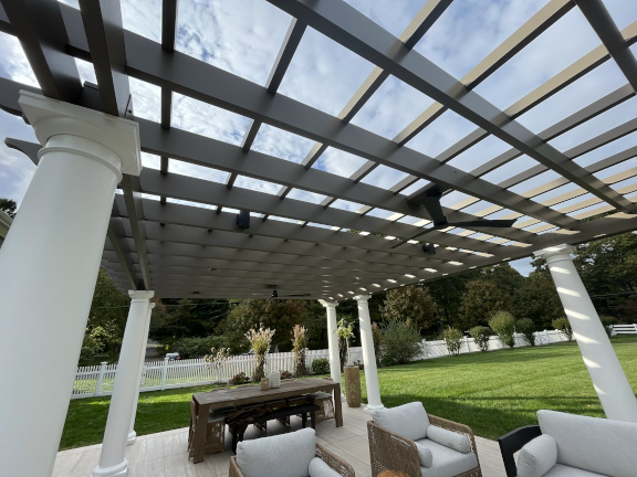 A simple fiberglass pergola beside a pool