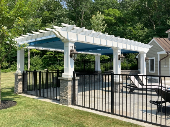 Poolside fiberglass pergola with canopy in Connecticut