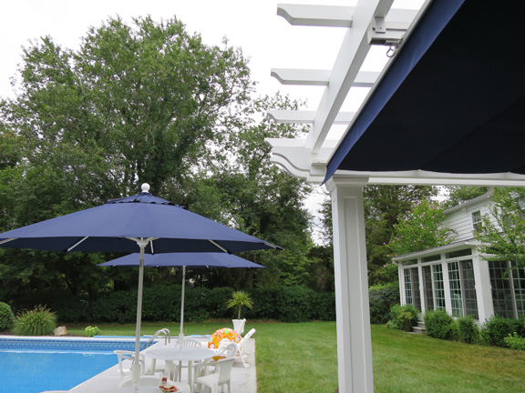 Poolside fiberglass pergola with canopy in Connecticut