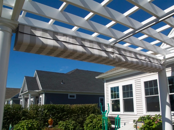 A fiberglass pergola with an overhead shade