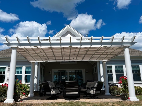 A fiberglass pergola with an overhead shade